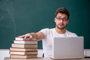 Young male student sitting in the classroom