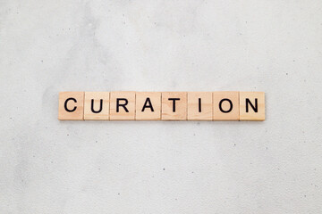 Top view of Curation word on wooden cube letter block on white background. Business concept