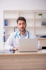 Fototapeta premium Young male doctor in telemedicine concept