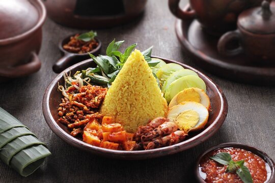 Tumpeng is an Indonesian cone-shaped rice dish with side dishes of vegetables and meat originating from Javanese cuisine of Indonesia. Traditionally featured in the slamatan ceremony.