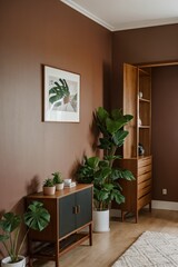 interior with wooden frame on a dark pale red wall, a sideboard and a pot with a monstera plant