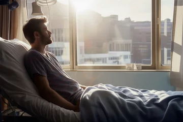 Fotobehang A man in a hospital bed. © calvinom