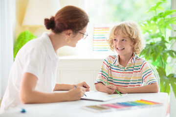 Child drawing. School kid painting a picture.