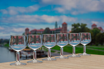 Polish vodka set on wooden table in front of Wawel castle in Krakow, Poland