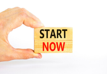 Start now symbol. Concept words Start now on beautiful wooden block. Beautiful white table white...