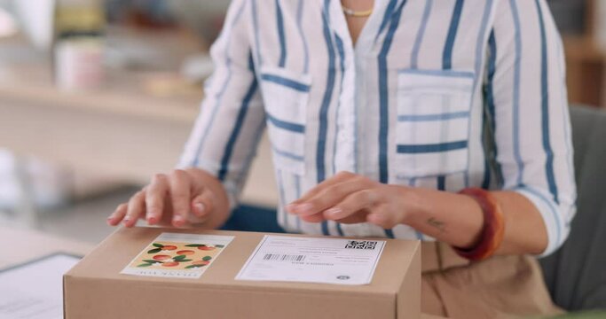 Delivery, woman and hand with sticker on box for online order, courier label or retail package in office. Stock, startup and sales of fashion store, boutique and clothing industry with packaging