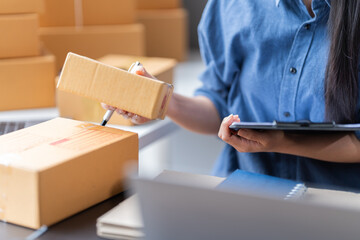 Close-up woman hand press calculator to calculate the company's financial results, tax, accounting, statistics, and analytical research.