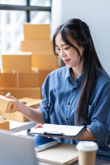 startup girl Small SME business owners work with laptop computers at work. with parcel paper boxes for delivery to customers online selling, Ecommerce,	