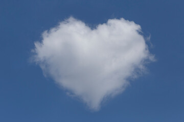 white fluffy valentine shaped cloud in a blue sky