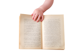 Baby toddler boy holds a book with pages of text in his hand, isolated on a white background. Child with an open book, close-up