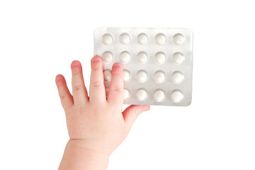 Baby toddler boy holding a pack of pills in his hand, isolated on a white background. Child with medicines, close-up