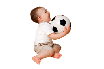 Happy baby boy plays with a soccer ball, isolated on a white background. A smiling child learns to play football with a big ball, isolated on a white background. Kid age one year