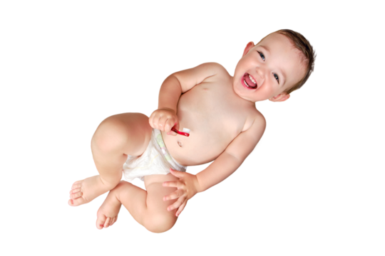 Happy toddler baby brushes his teeth with a toothbrush, isolated on a white background. A smiling child boy cleans his teeth with a brush on his own, isolated on a white background. Kid age one year