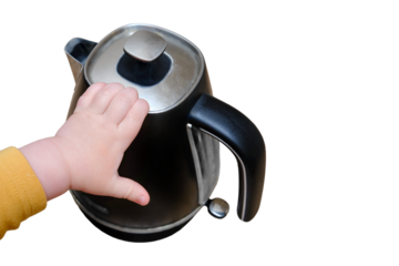 Toddler baby boy holds a hot kettle with boiling water, isolated on a white background. Child safety issues in the home room, little kid