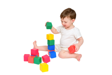 Happy baby play educational toys on studio, isolated on white background. Portrait of a smiling child playing while sitting on the floor, isolated on white background. Kid about two years old