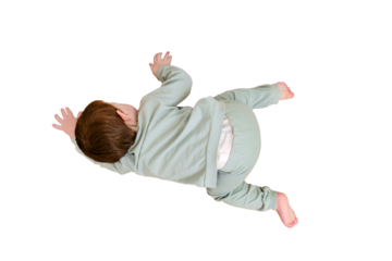 Little baby peeps under the door, isolated on white background. Small child looks through the crack of a closed door, isolated on white background. Kid aged two years