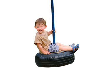 A smiling child enjoys playing on a car tire turned into a swing, isolated on white background. A...