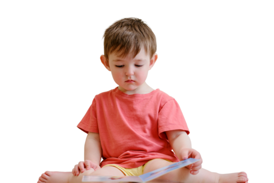 The cute baby is playing with the colorful picture book, flipping through the pages and touching the pictures, isolated on white background. The little child is lost in thought as he reads book