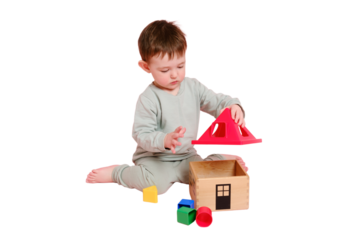 Happy toddler baby plays sorter with geometric shapes on studio, isolated on white background. Child boy plays educational toys. Kid age one year eight months, full height