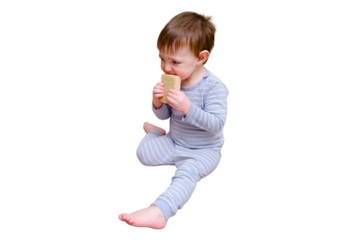 Toddler baby plays with household chemicals and detergent from the closet, isolated on white background. Child boy with detergent bottle in home living room. Kid age one year nine months