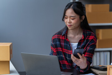 startup girl Small SME business owners work with laptop computers at work. with parcel paper boxes for delivery to customers online selling, Ecommerce,	