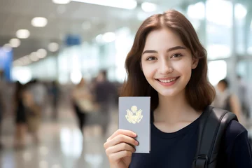 Fotobehang Beautiful young Asian woman smiling holding a passport in the airport terminal, Nomad visa, Travel visa © rabbizz77