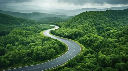 Foto op Plexiglas Aerial top view beautiful curve road on green forest in the rain season. © Oulaphone
