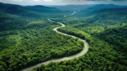 Foto op Canvas Aerial top view beautiful curve road on green forest in the rain season. © Oulaphone