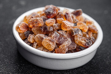 cane sugar rock sugar crystals pieces candy brown sugar candied sugar big rock caramel eating appetizer meal food snack on the table copy space food background rustic top view