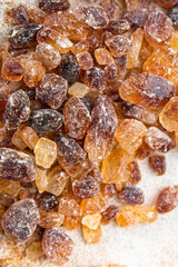 cane sugar rock sugar crystals pieces candy brown sugar candied sugar big rock caramel eating appetizer meal food snack on the table copy space food background rustic top view