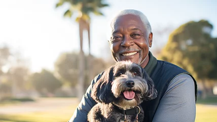 Rolgordijnen Happy black senior man with small dog in the park. Positive emotions, pet concept.   © BlazingDesigns