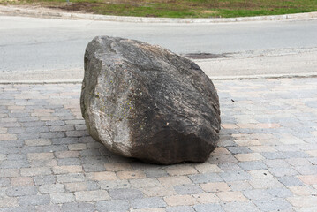 A big stone in the middle of the road
