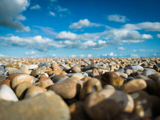 Shallow focus of large stones seen on a deserted beach. The stones are used as part of coastal defences in the east of the UK.