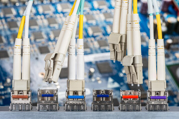 Optical fibre patch cords and gbic connected to the switch with Print Circuit Board in Background