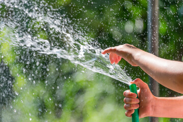 A child watering with a hose