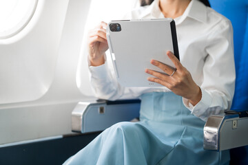 travel and technology Fly in first class Beautiful Asian businesswoman working using laptop computer while sitting on airplane