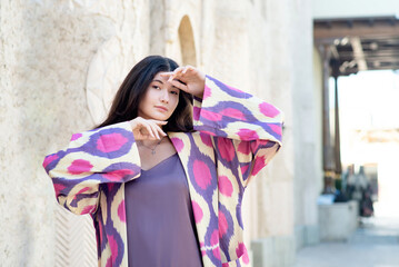 Beautiful fashion model, girl in traditional Uzbekistan fashion dress with ikat pattern. Tashkent,...