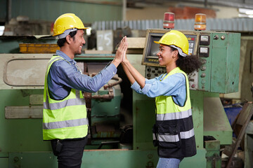 workers or engineers giving high five pose in the factory