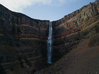 Huge blue waterfall flowing down the mountain
