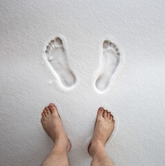 Man walks barefoot in a snowdrift, hardening her body. Hardening for immunity. Body rejuvenation. strengthening immunity - 658745817