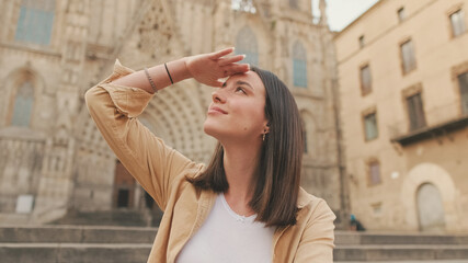 Close-up of young woman traveler sitting on the square of the old city