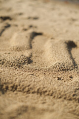 Fototapeta na wymiar Texture of the sand prints on the beach.