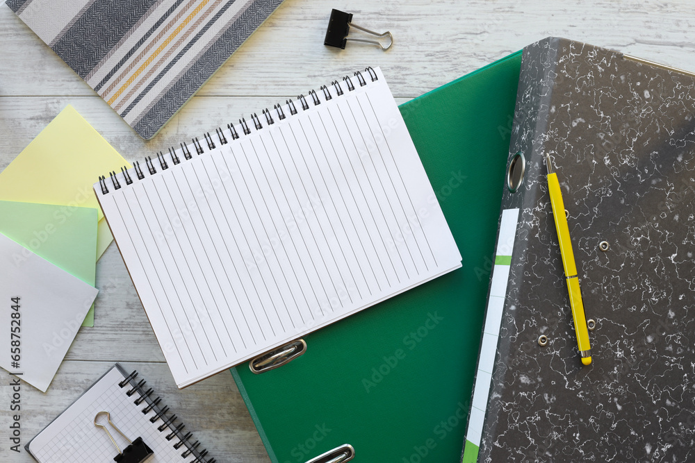 Poster spiral notepad on a green folder on the table. free space for business concept template and banner.