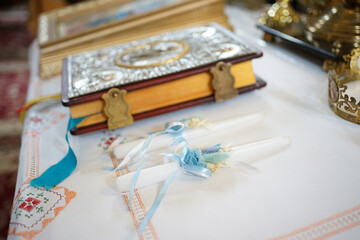 Gospel and ceremonial candles in the church. Wedding ceremony in the church.
