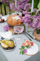 homemade pie in rustic style. beautiful picnic in the garden with lilac flowers. vintage dinner outdoor