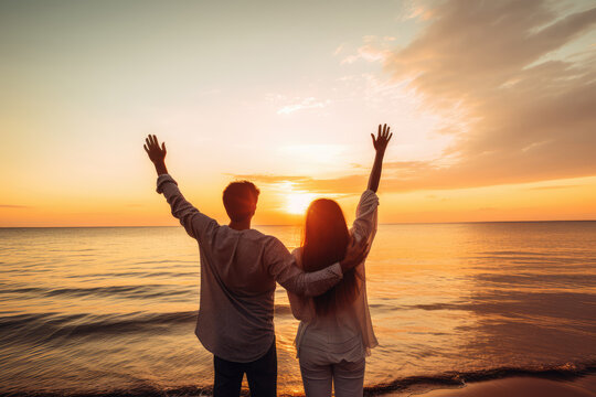 Happy young couple on the beach at beautiful sunset. Travel and vacation concept.