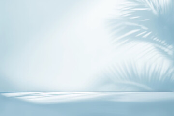 Blurred shadow from palm leaves on the light blue wall. Minimal abstract studio background for...