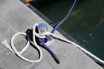 Thick hemp rope on the pier in the seaport.