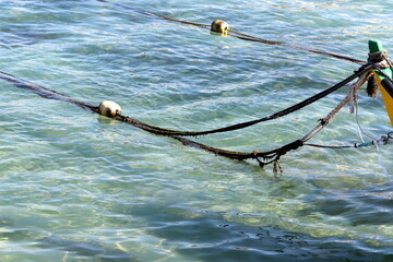 Thick hemp rope on the pier in the seaport.