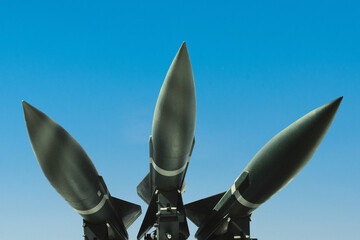 Three missiles weapons rockets on a blue sky, concept. War in Israel and Palestine. Armed conflict